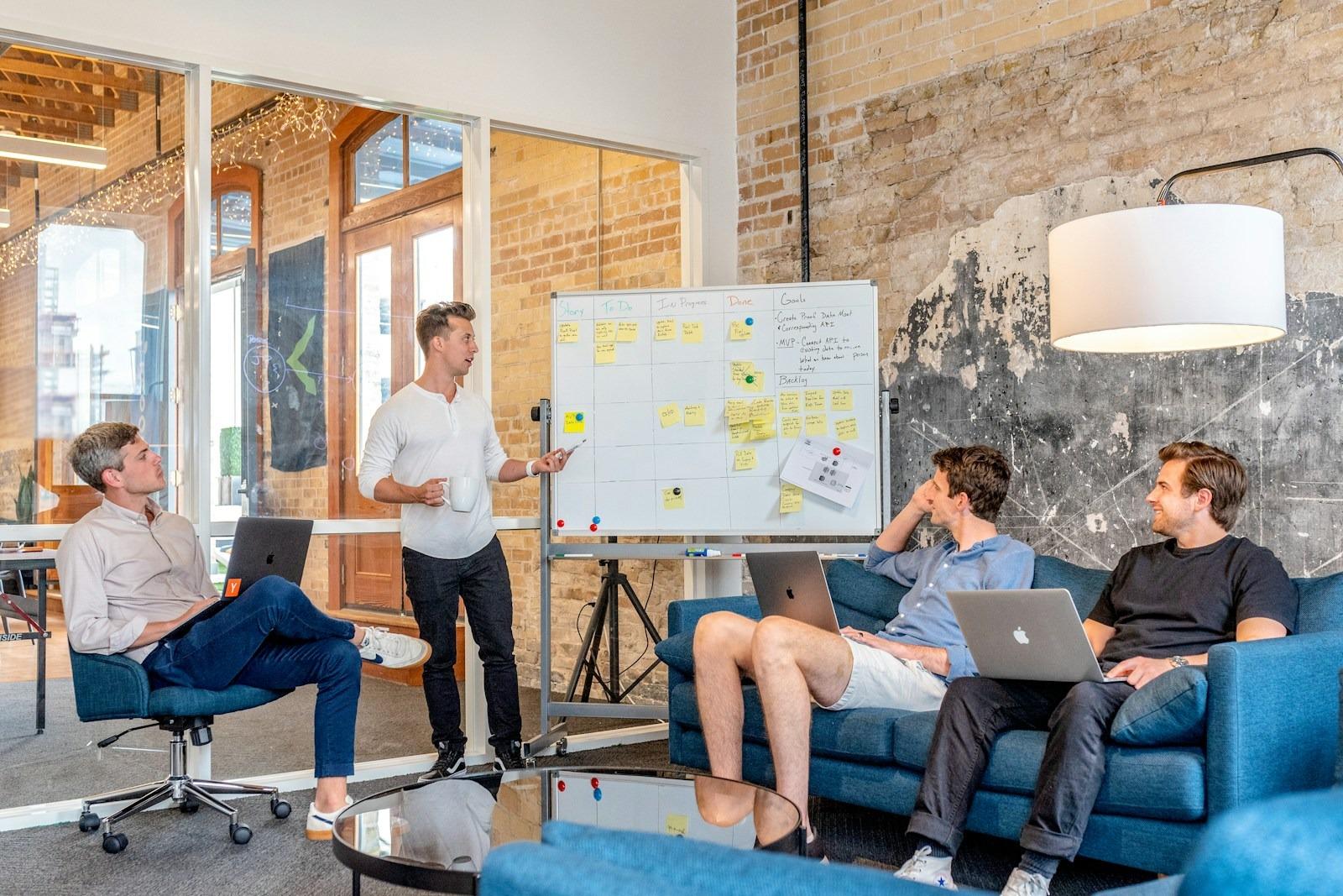 A facilitator leading a hands-on team workshop at a planning board — upskilling in session